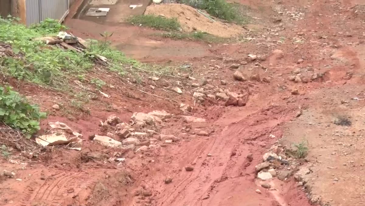 Rua de terra com barro vermelho molhado no bairro Camurugi, em Guarapari
